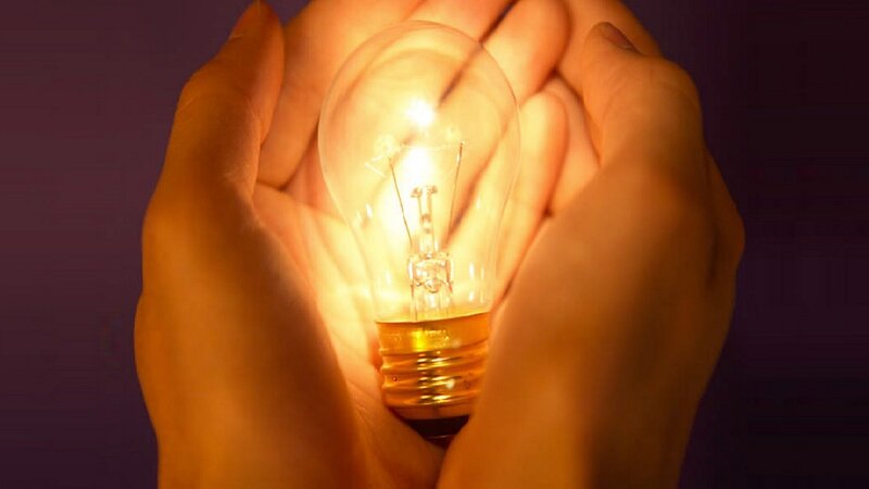 Hands Holding Light Bulb — Yellow