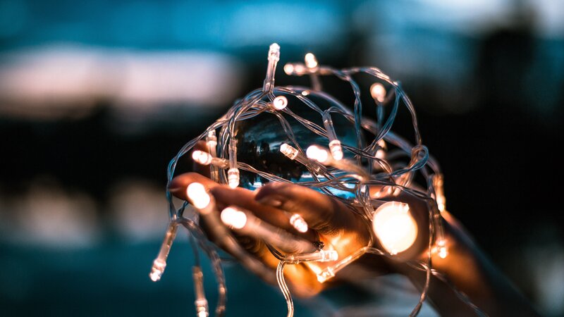 Hands Holding Lights — Blue