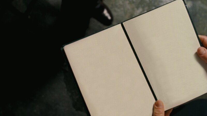hands holding open notebook