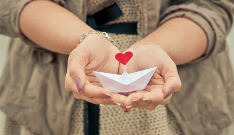 Hands Holding Paper Boat