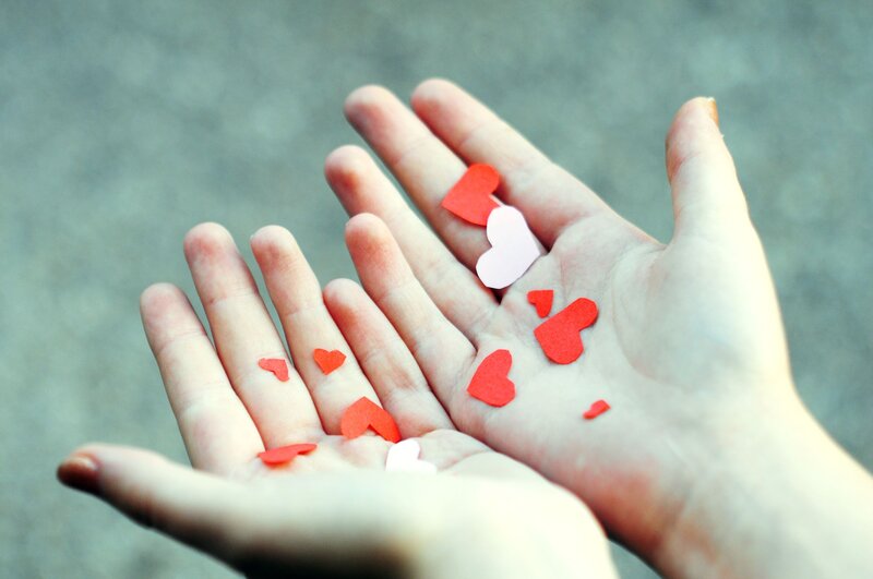 Hands Holding Paper Hearts — Red