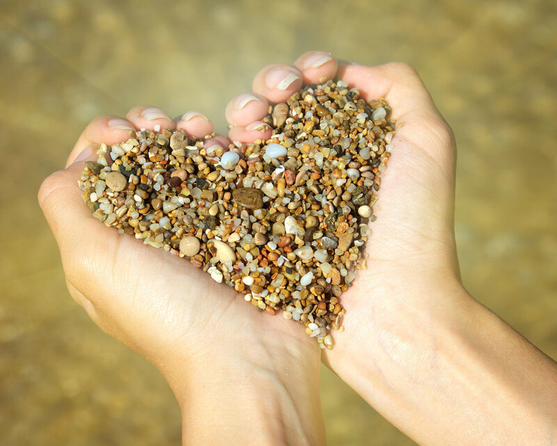 Hands Holding Pebbles