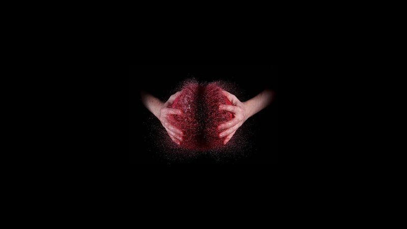 hands holding red powder