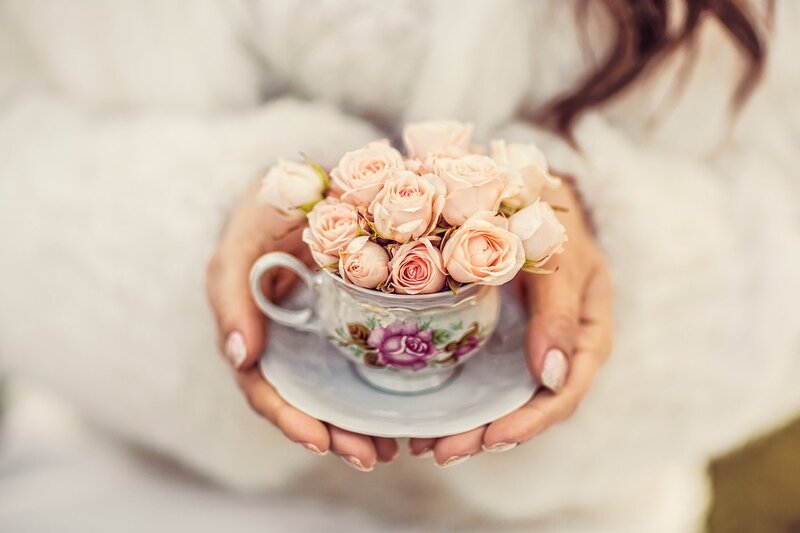 Hands Holding Roses in Cup