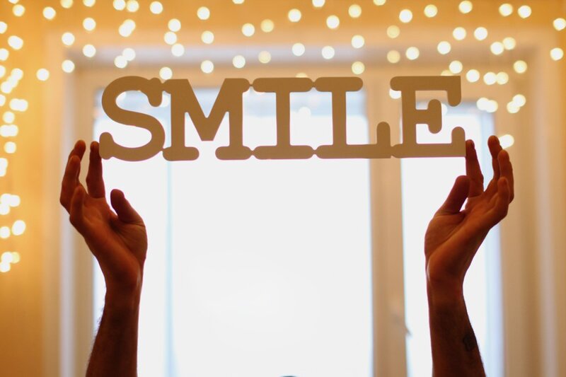 Hands Holding Smile Sign
