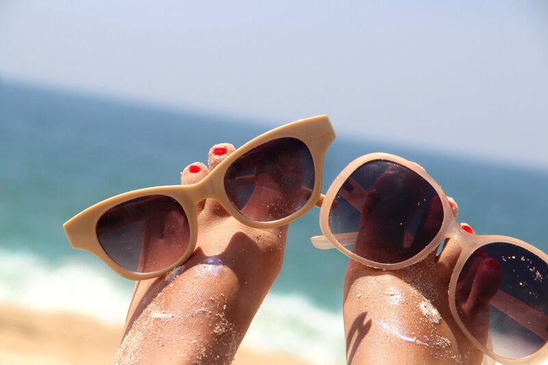 Hands Holding Sunglasses