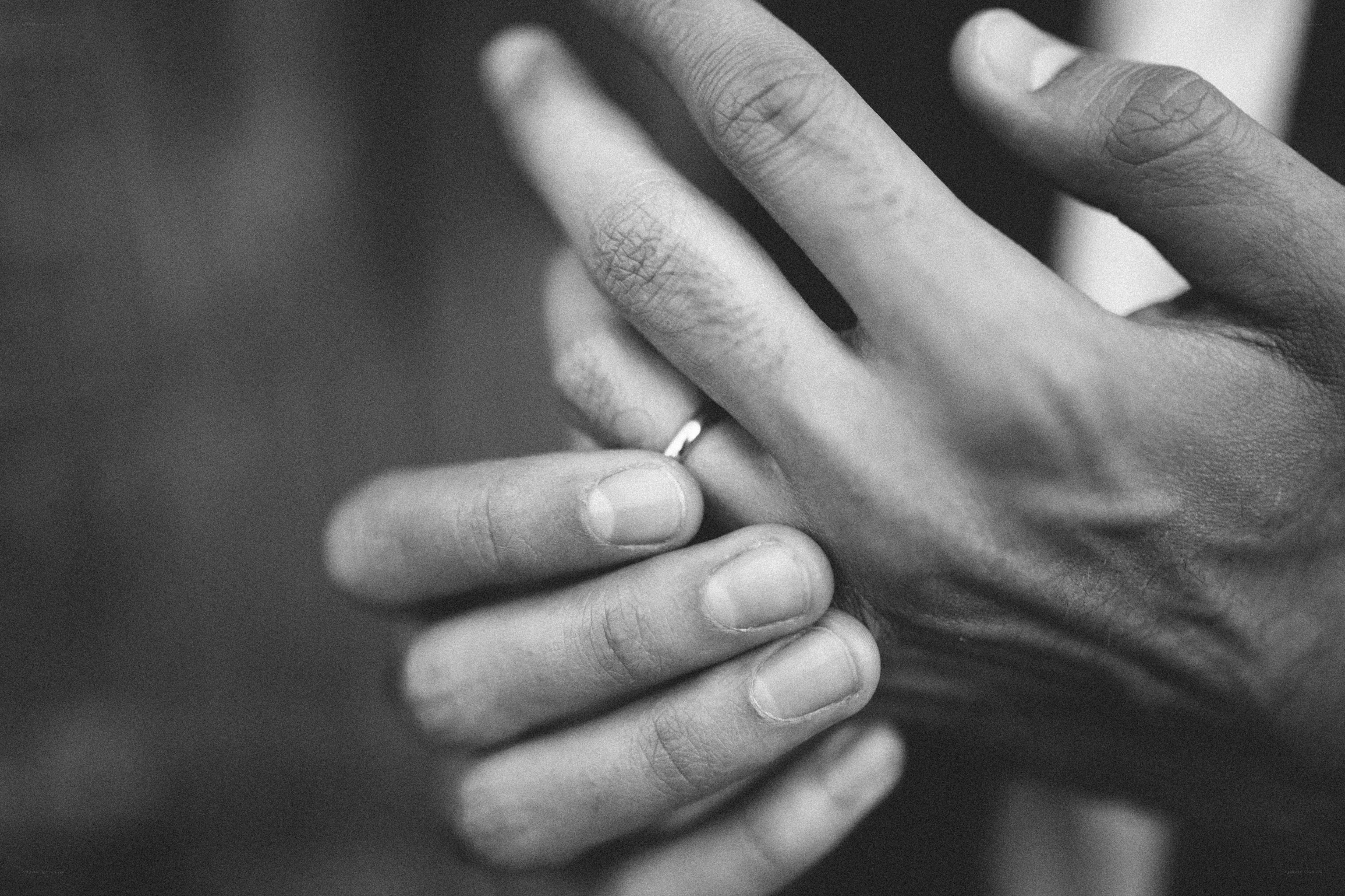 hands holding wedding ring