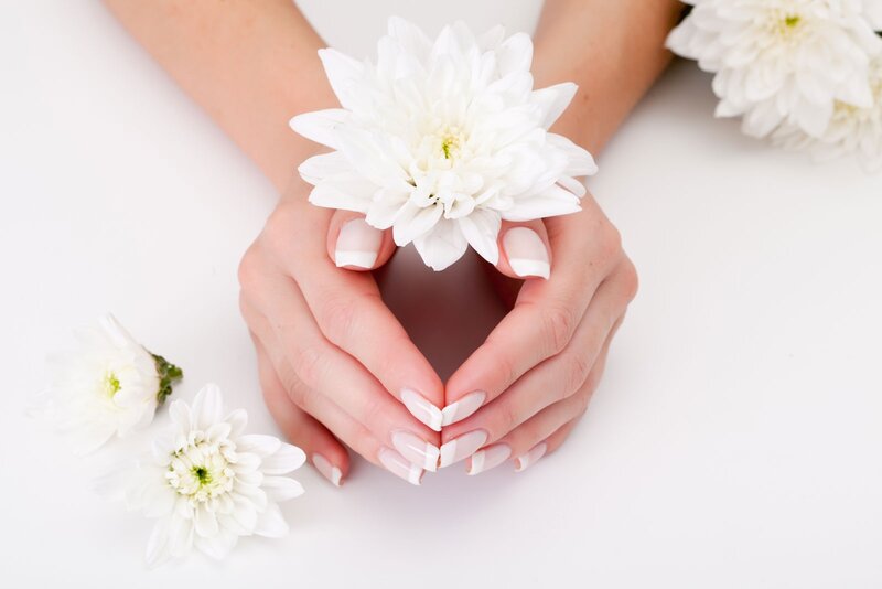 Hands Holding White Flower — Serene