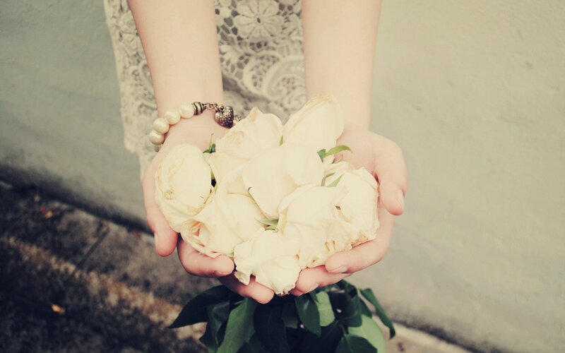 Hands Holding White Roses