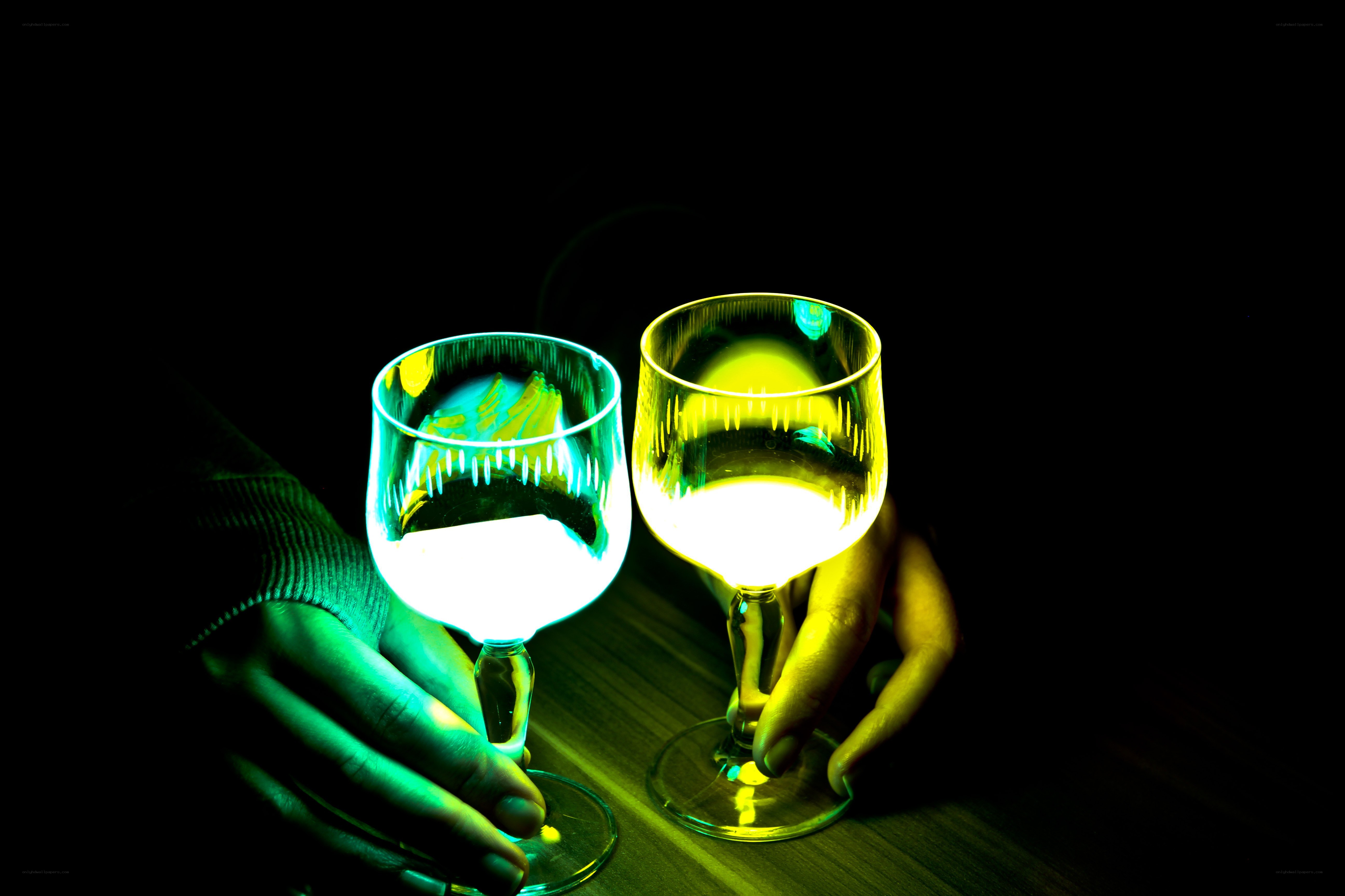 Hands holding wine glasses