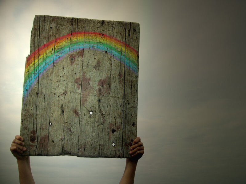Hands Holding Wooden Sign — Gray, Dramatic, Photograph