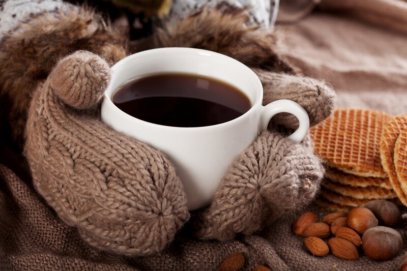 Hands in Mittens Holding Cup