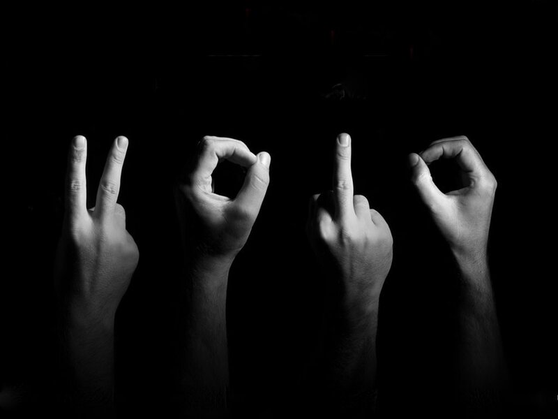 Hands making gestures in dark