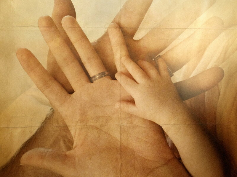 hands of a parent and child
