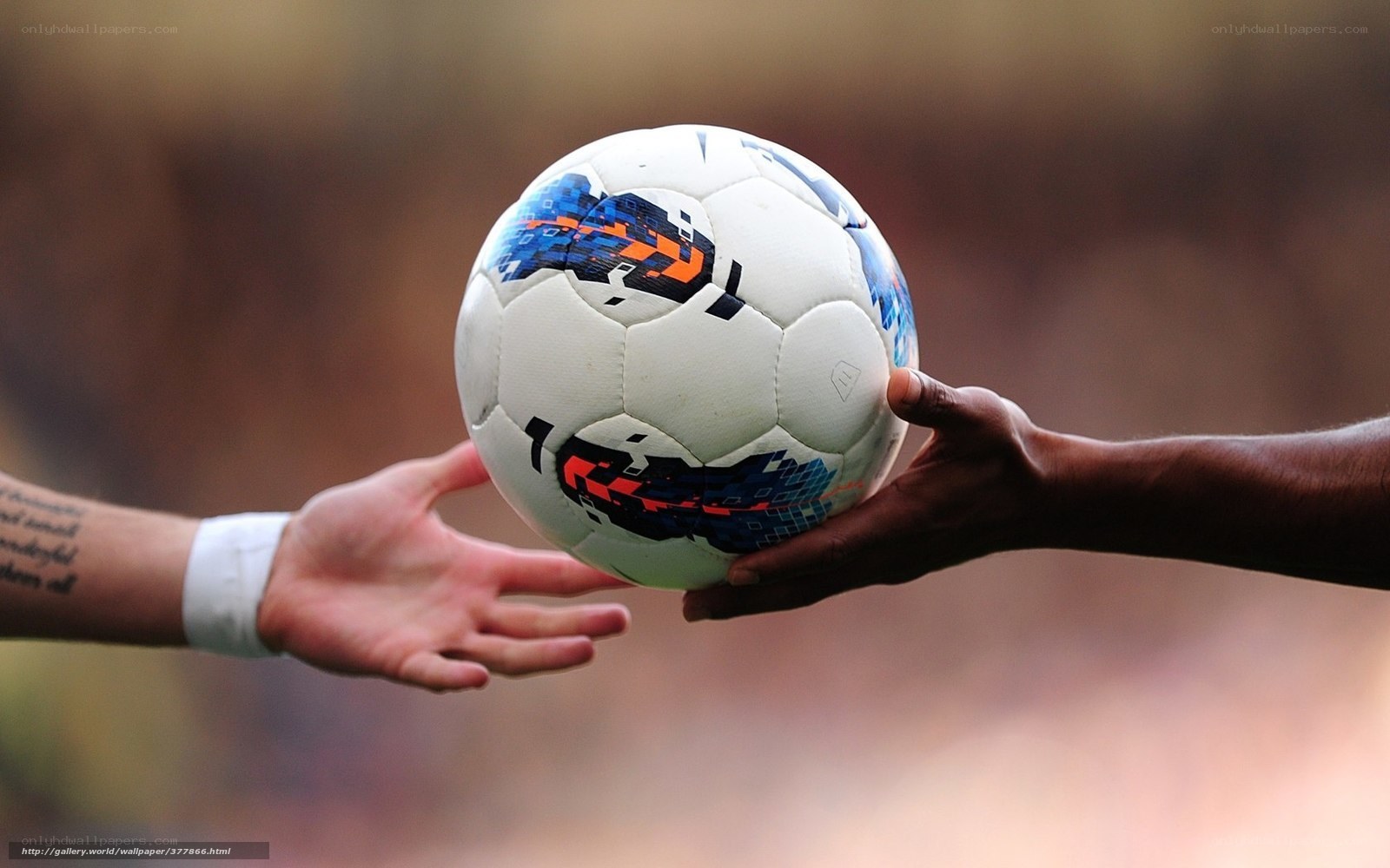 hands passing soccer ball