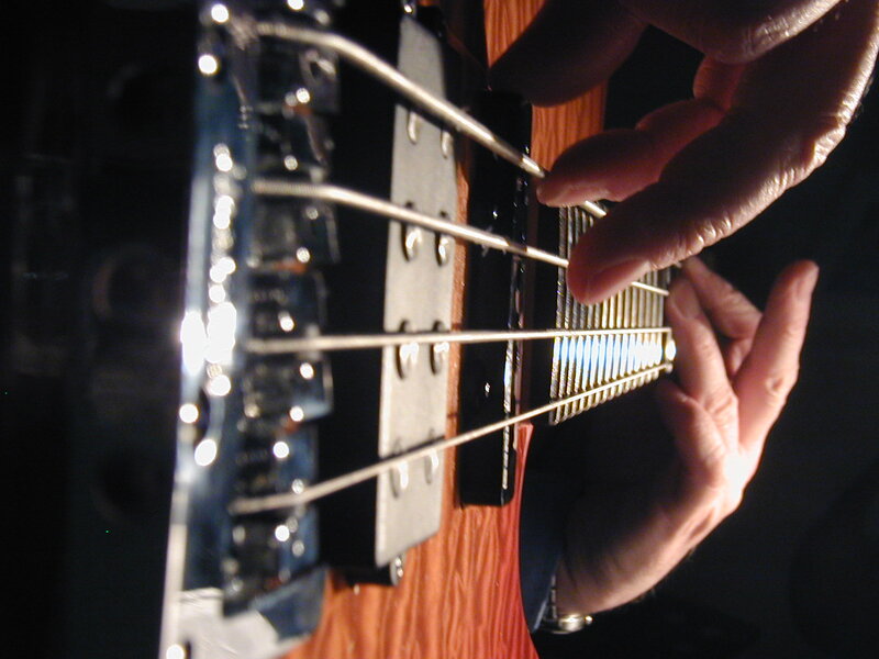 Hands Playing Bass Guitar — Brown