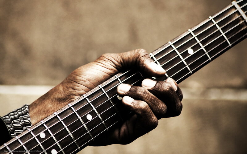 hands playing bass guitar