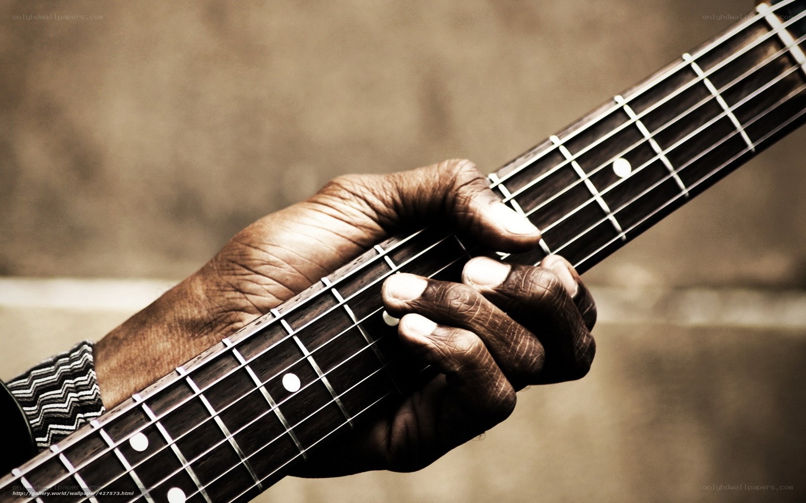 hands playing bass guitar