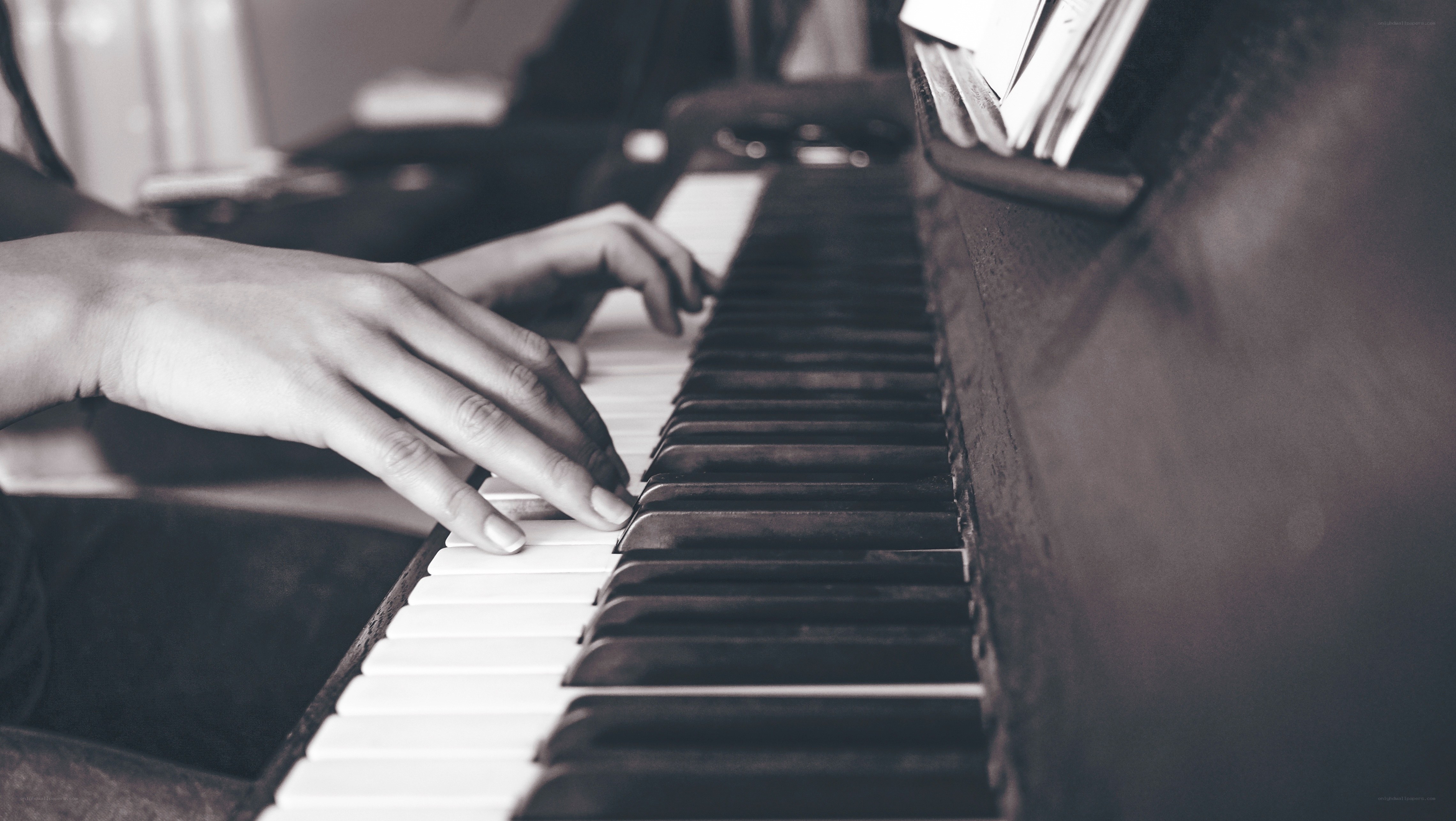 hands playing piano keys