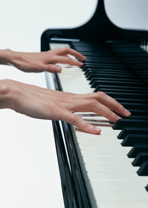hands playing piano keys