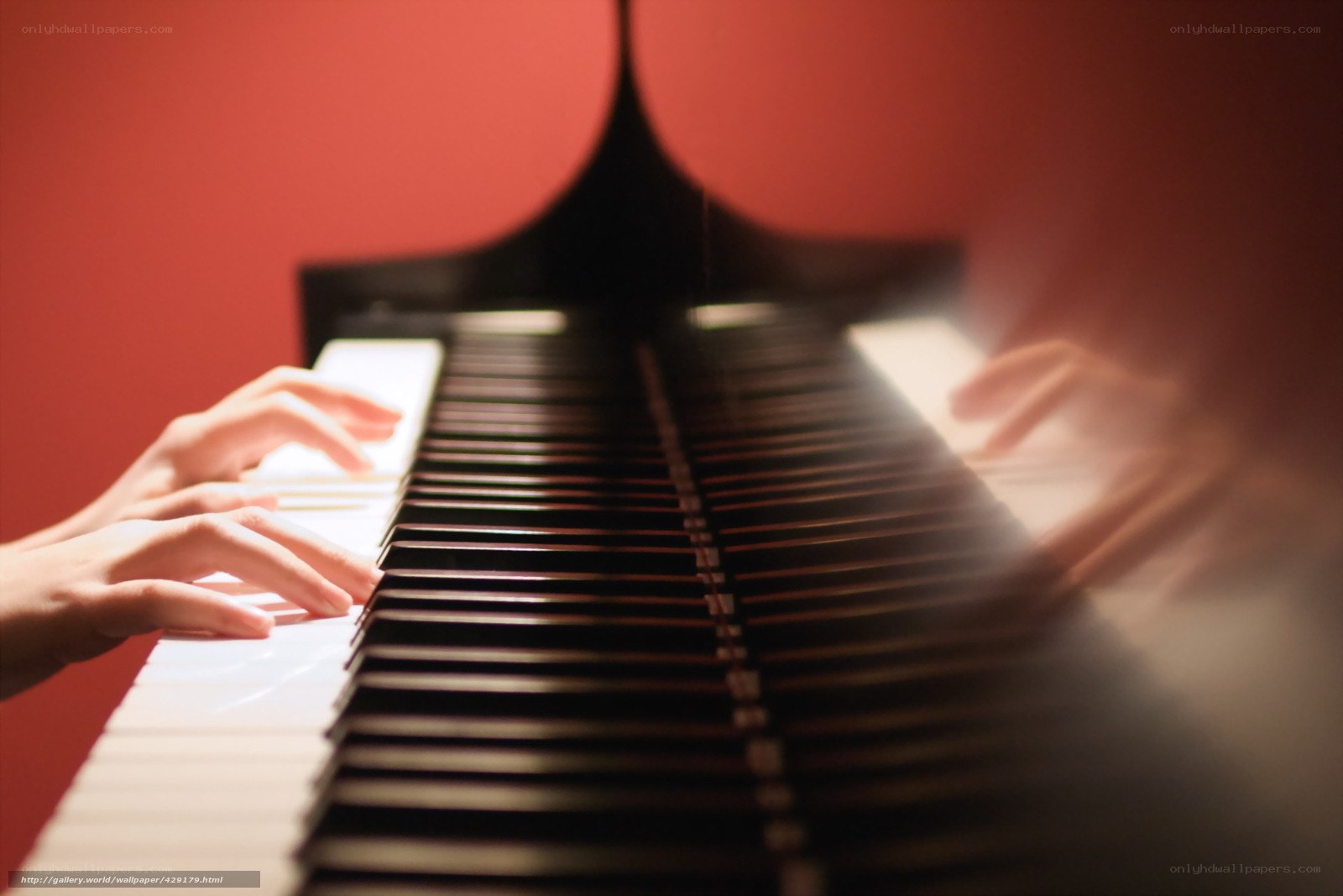 Hands playing piano keys