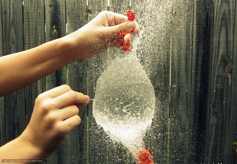 Hands Popping Water Balloon