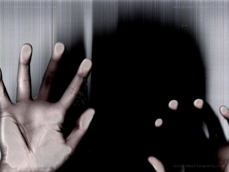 hands pressed against glass