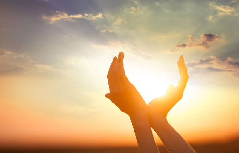 Hands Raised at Sunset