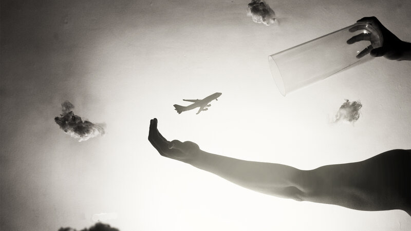 Hands reaching for a plane
