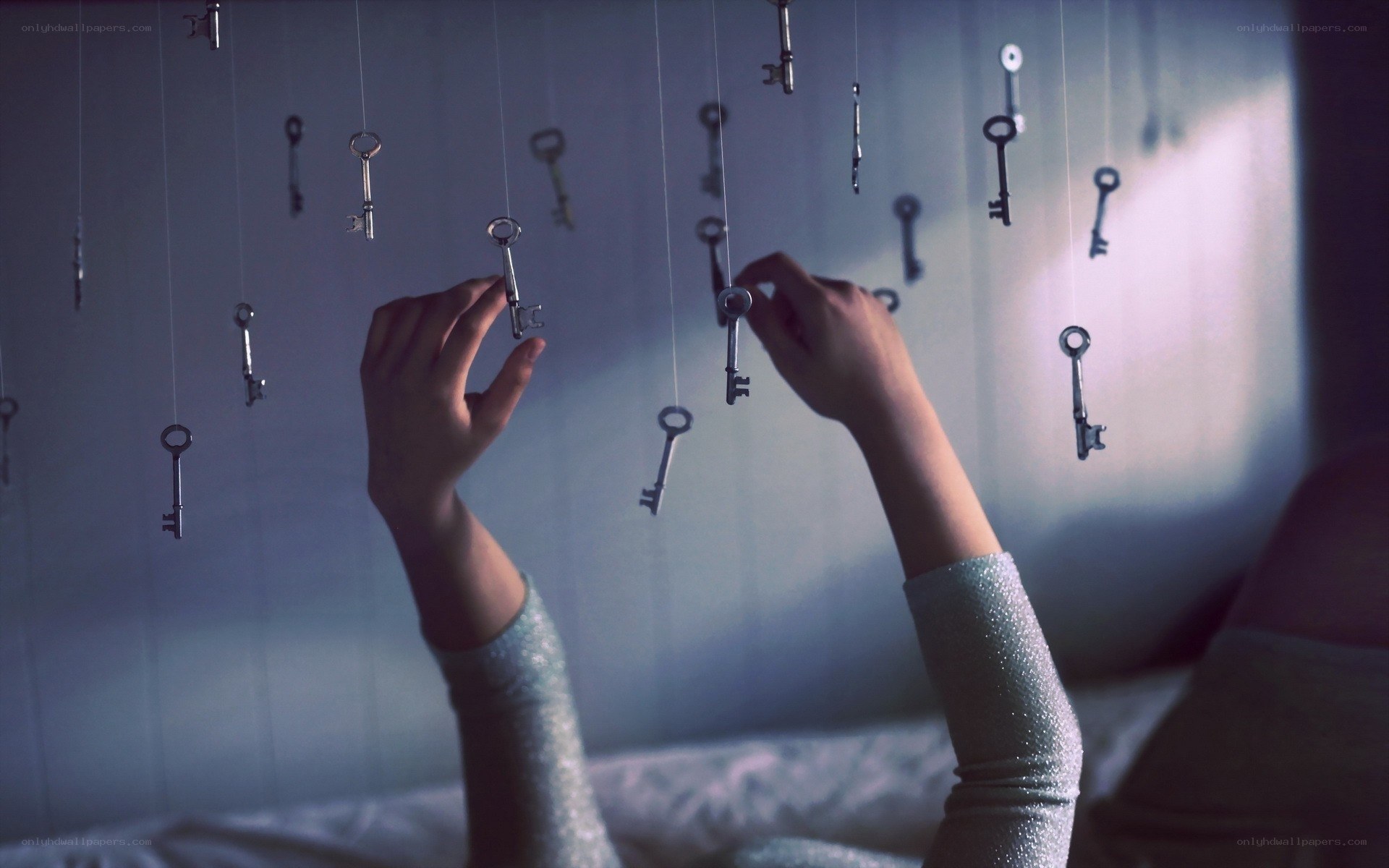 Hands reaching for hanging keys