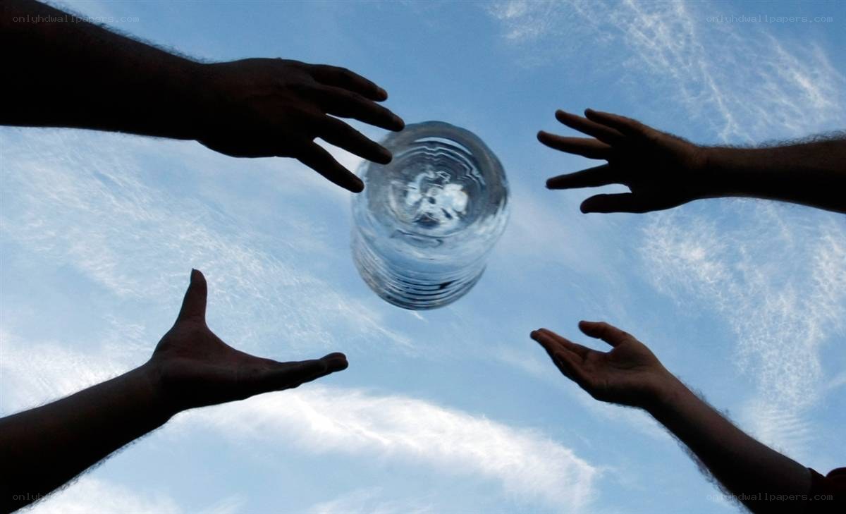 Hands reaching for water bottle