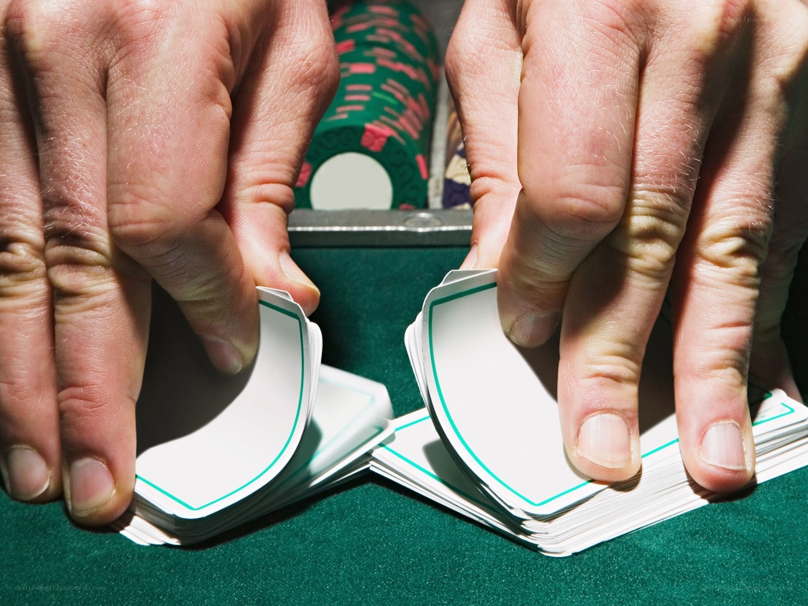 hands shuffling cards at table
