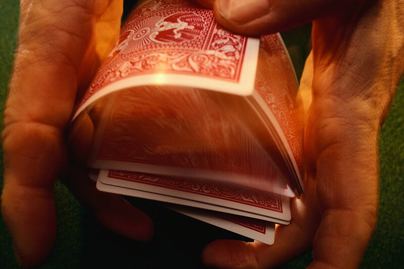 Hands Shuffling Cards — Red