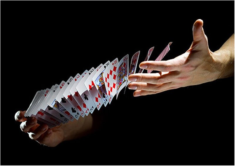hands shuffling playing cards