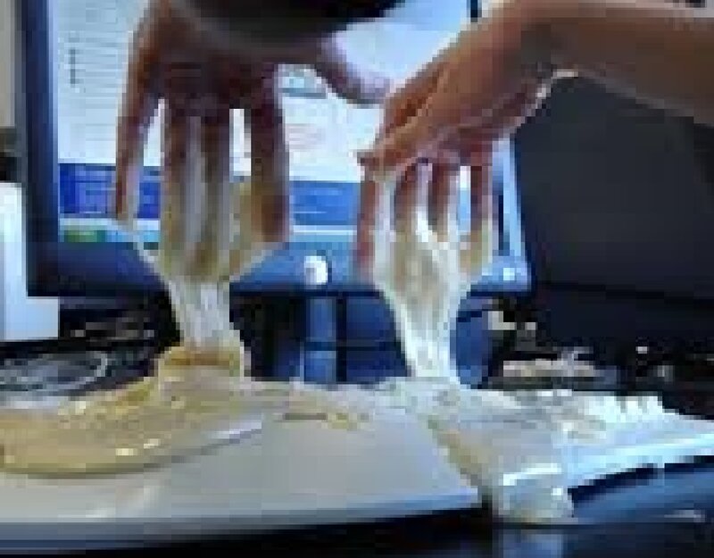 Hands Stretching Dough