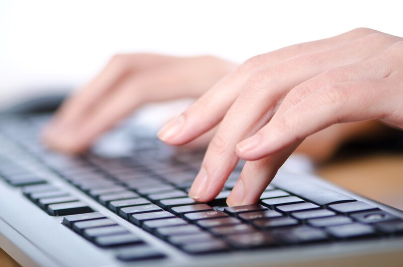hands typing on keyboard
