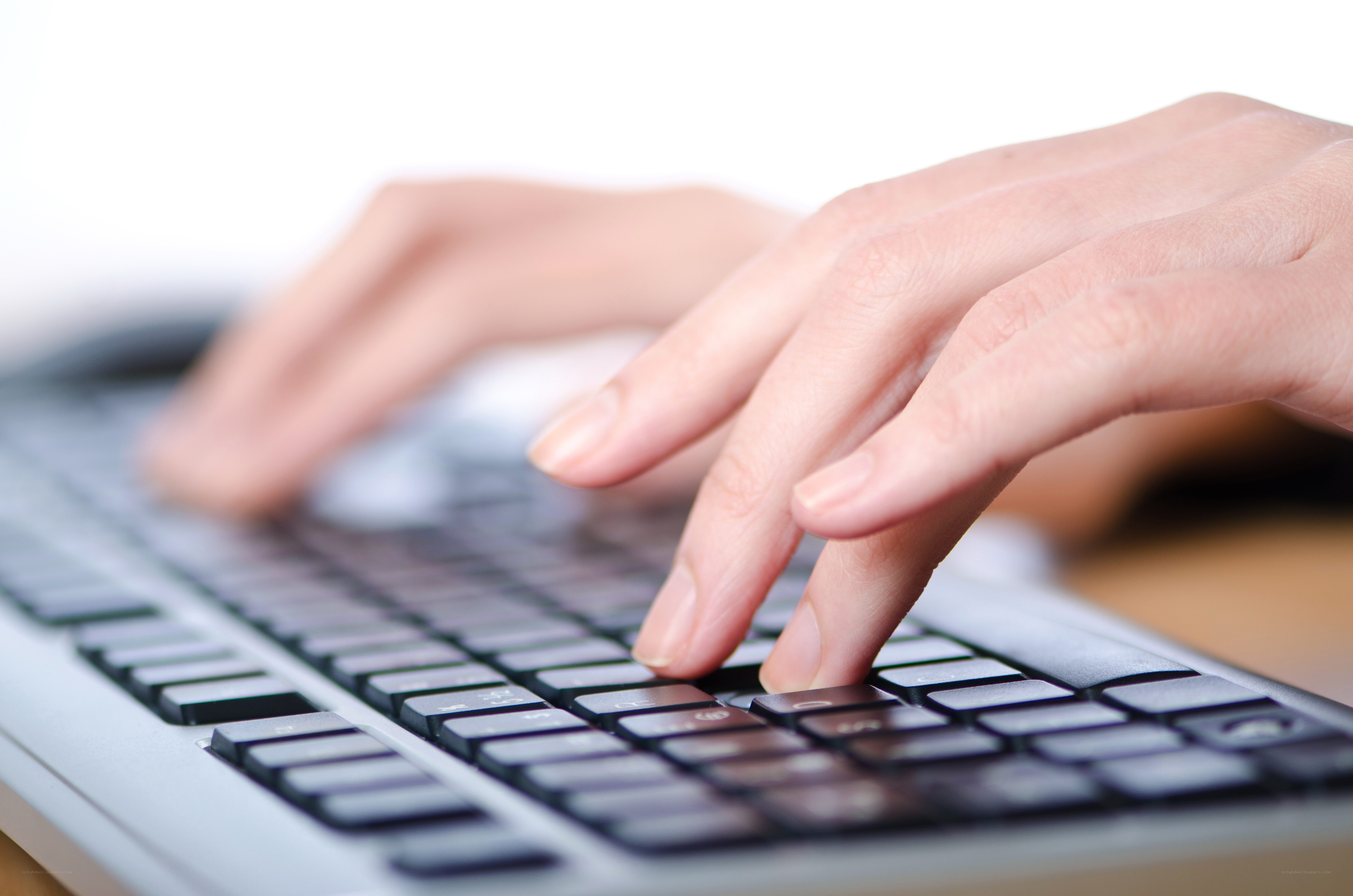 hands typing on keyboard