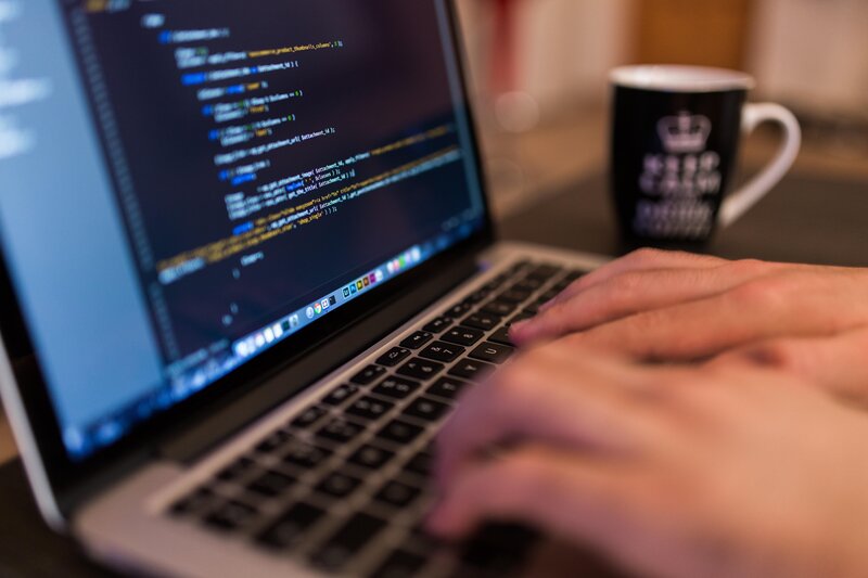 Hands Typing on Laptop — Black