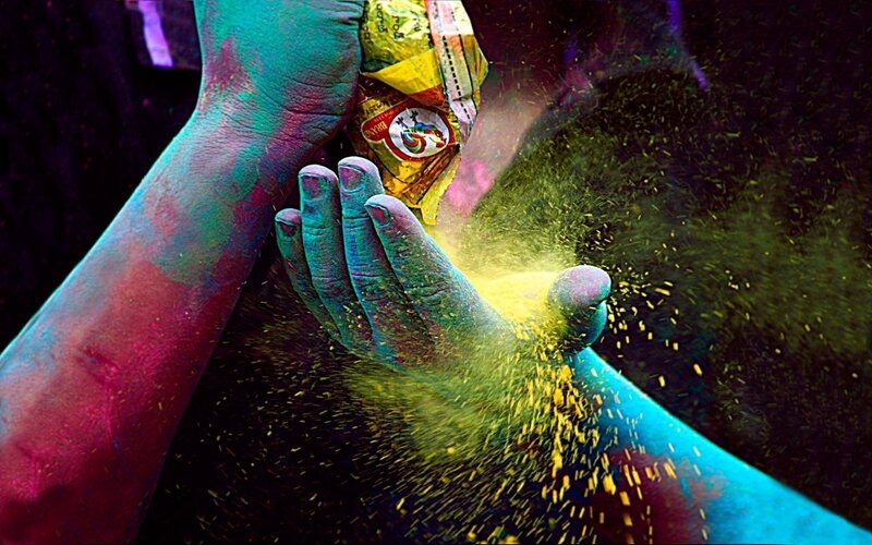 hands with colorful powder