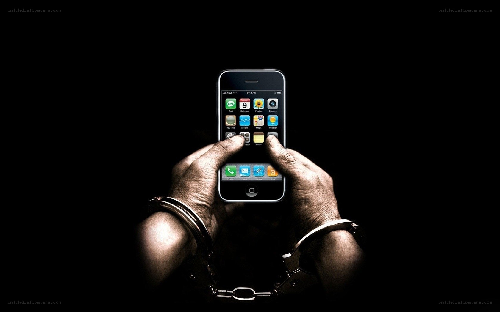 hands with handcuffs holding smartphone