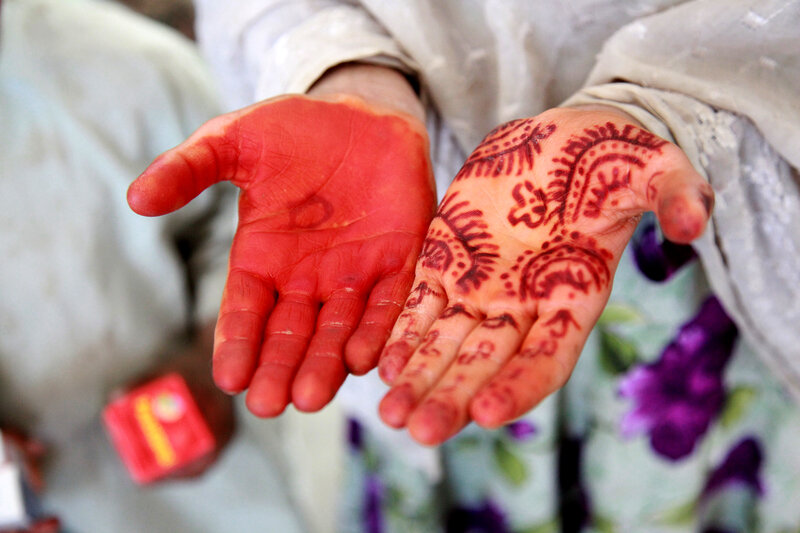 Hands with henna and red powder