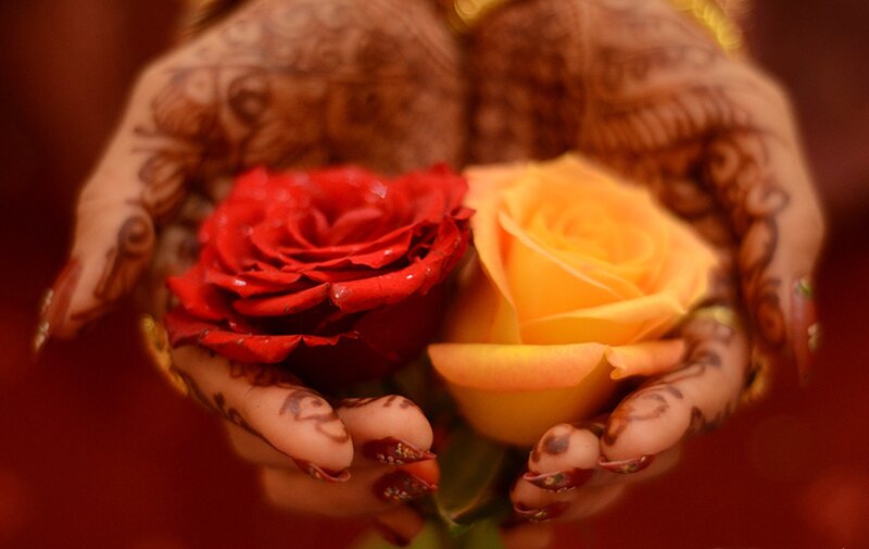 Hands with Henna Holding Roses