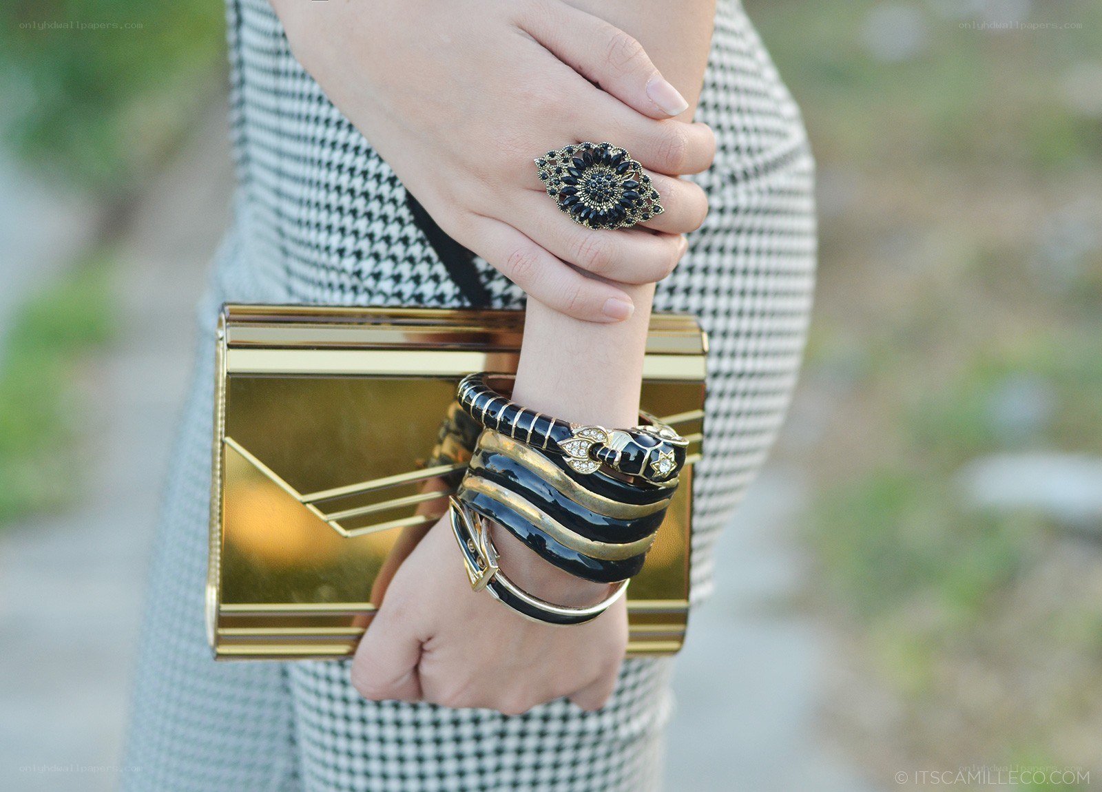 hands with jewelry and clutch