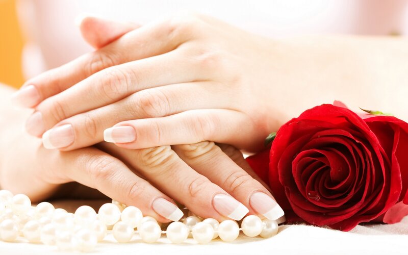 hands with manicure and rose