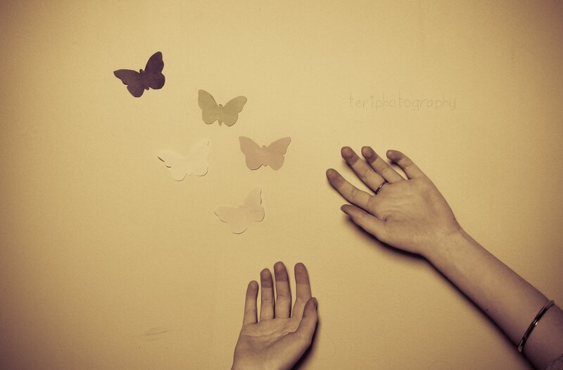 Hands with Paper Butterflies