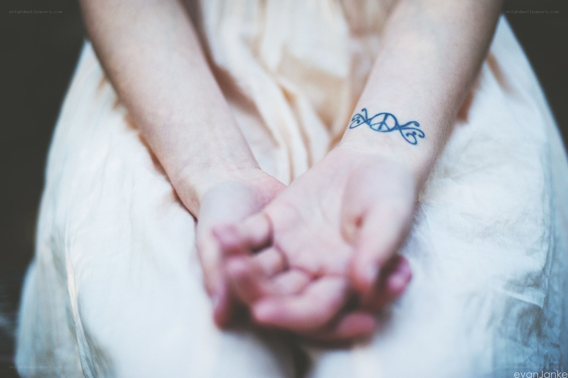 hands with peace tattoo