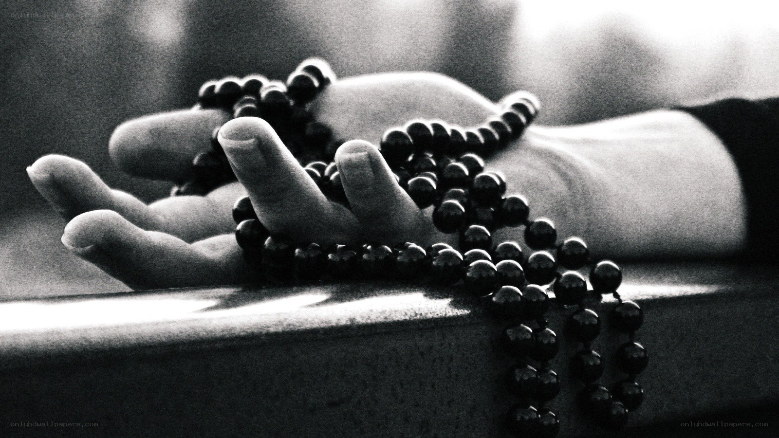 hands with prayer beads