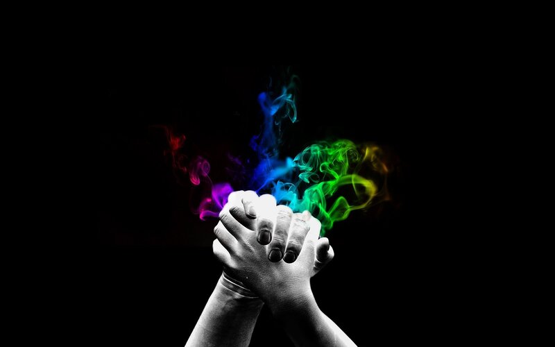 hands with rainbow smoke
