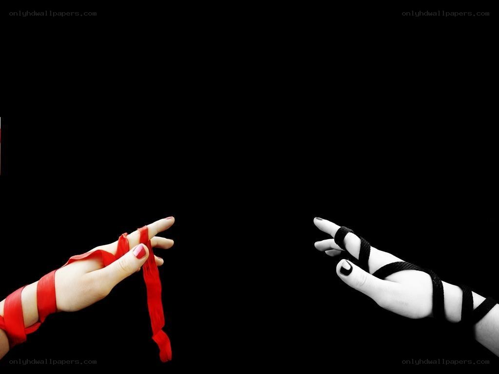 hands with red and black ribbons