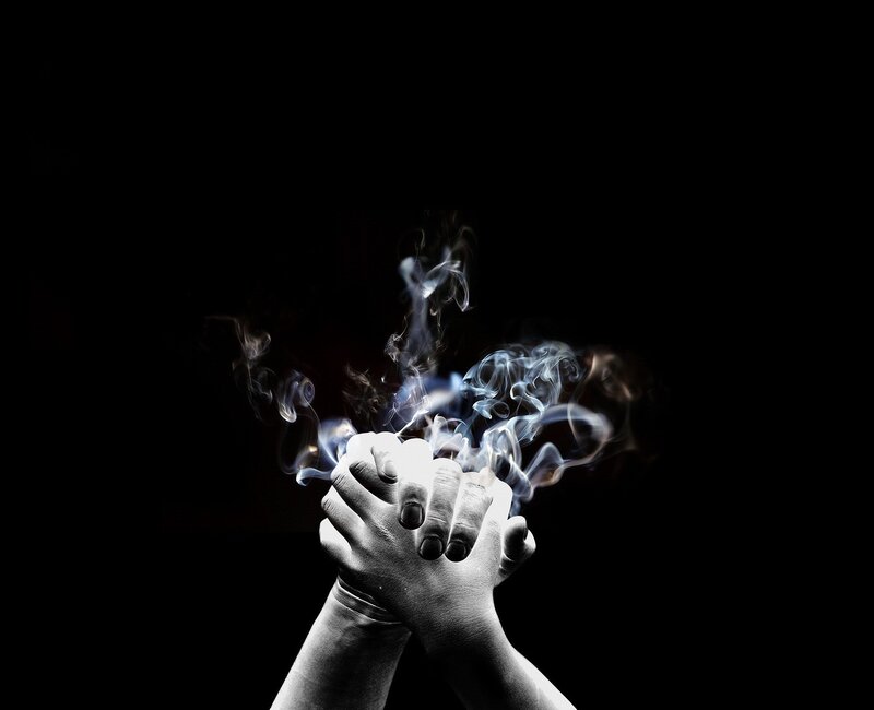 hands with smoke